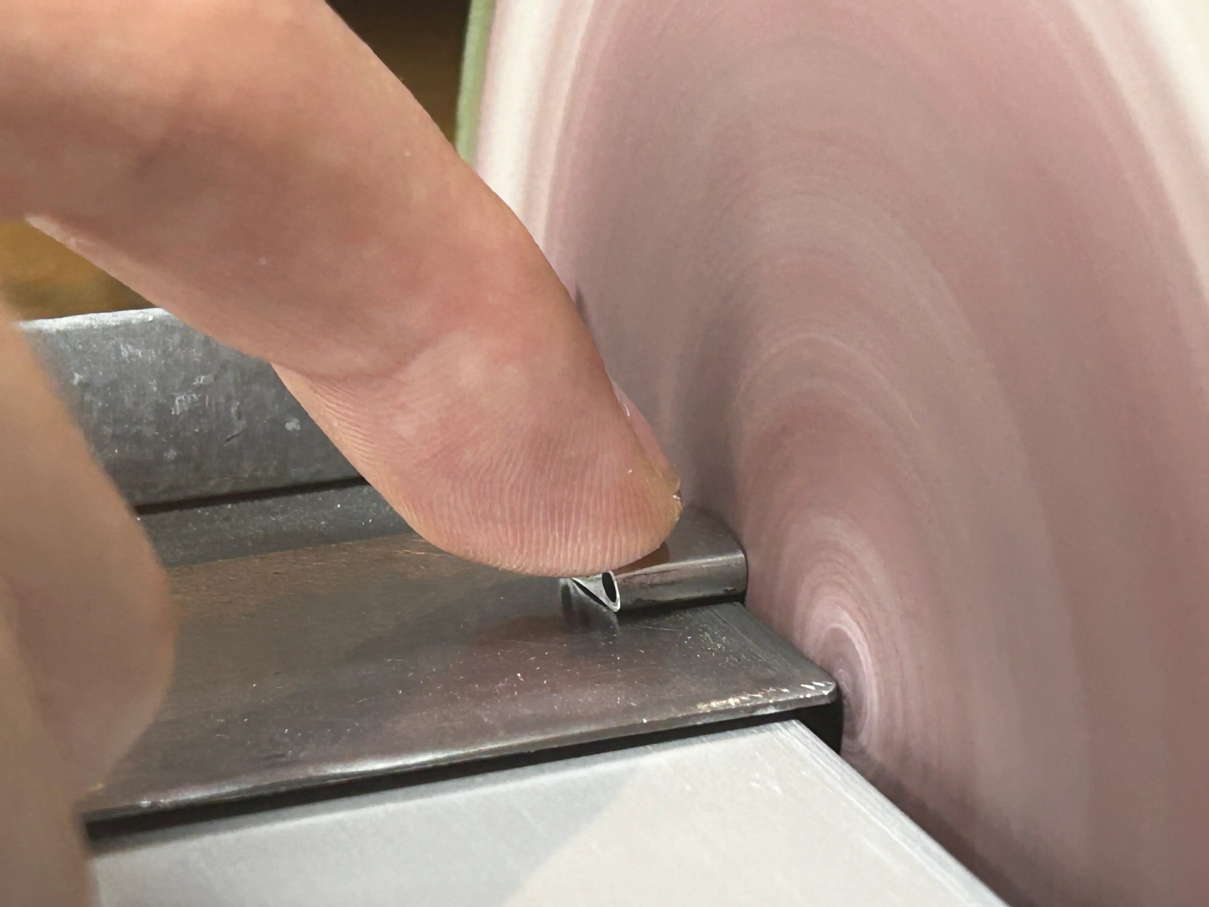 Filing away excess material from a laser welded element.