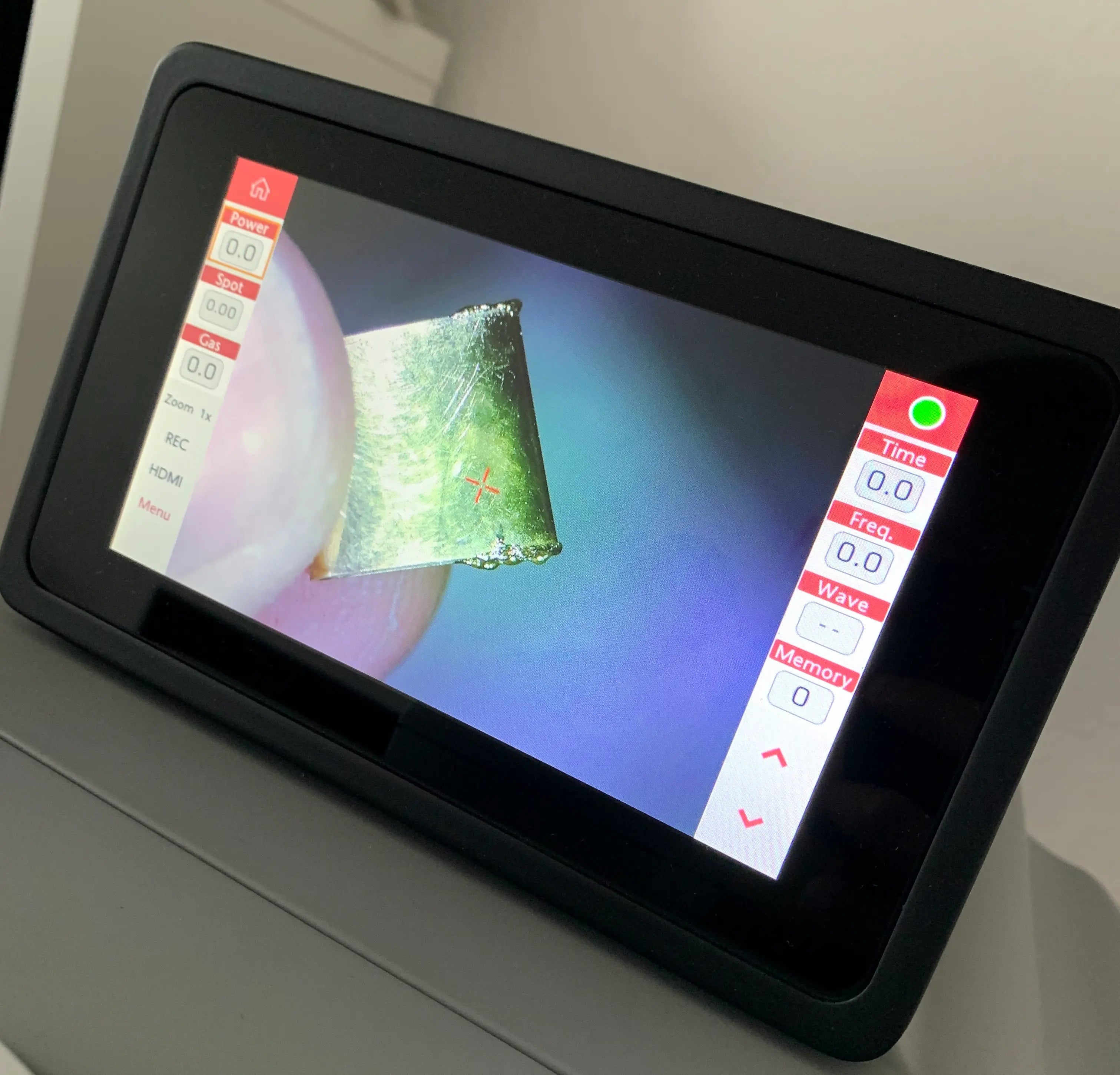Display of a laser welding machine where you can see how extra material is added to a worn part of a watch bracelet.